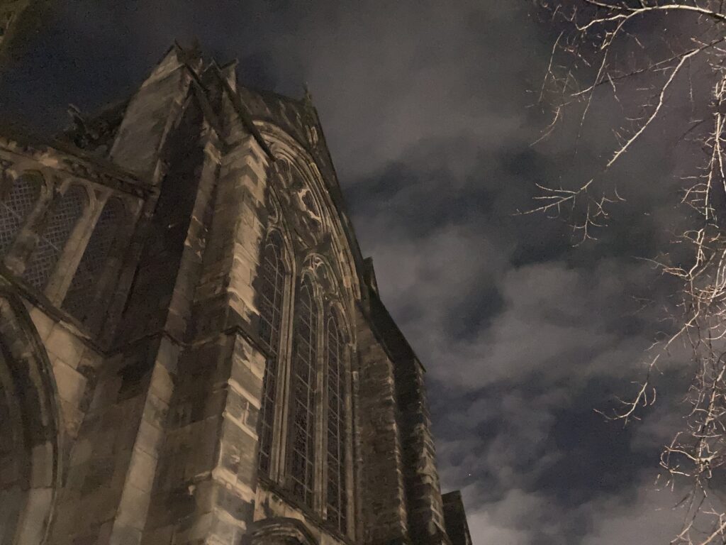 Glasgow Cathedral at night with cloudy skies overhead. The perfect backdrop for Connie MacLeod's new music video, I Love Your Name coming in 2026